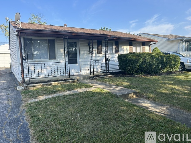 A house with a brown roof and a white door is available for rent.