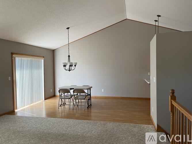 A dining room with a table and chairs.