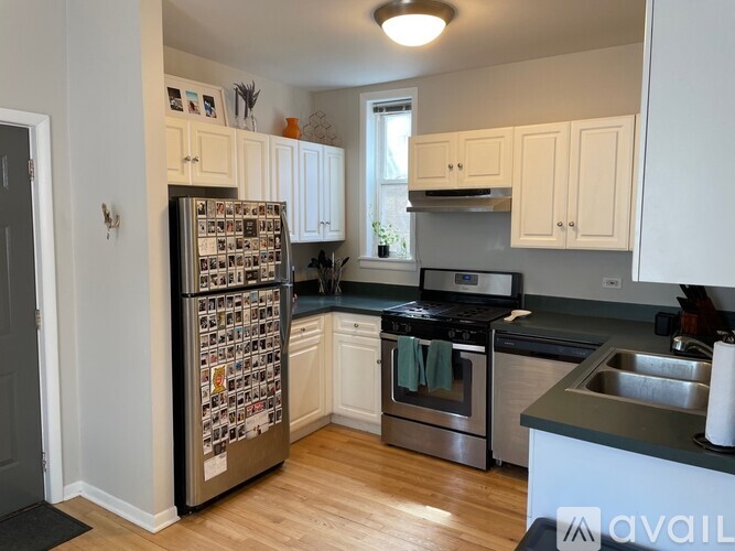 A kitchen with a refrigerator covered in photos.
