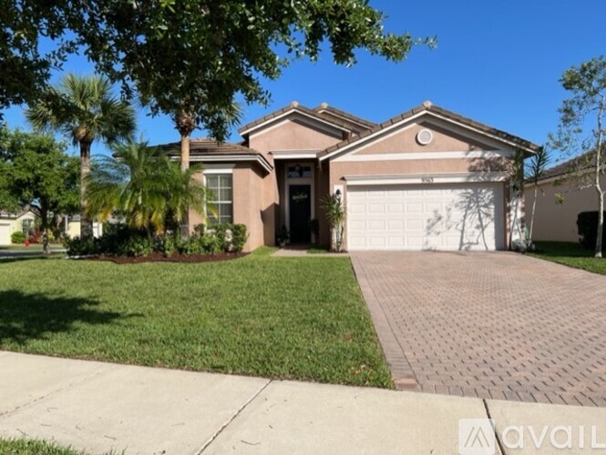 A house with a driveway and a garage is for sale.