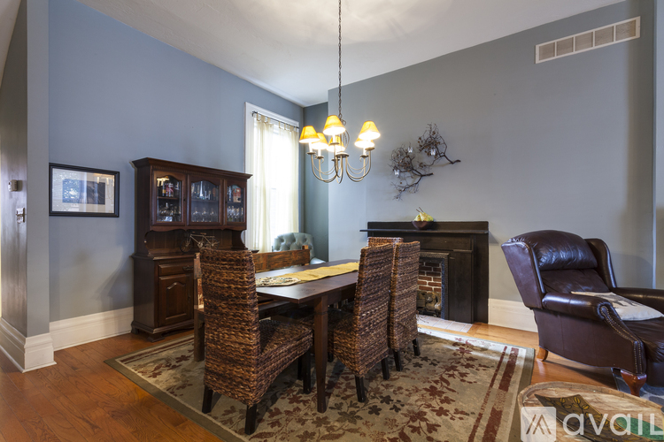 A living room with a brown leather chair and a wooden table.