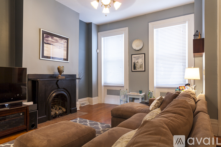 A living room with a fireplace and a couch.