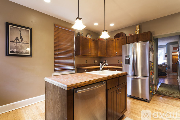 A kitchen with wooden cabinets and stainless steel appliances.