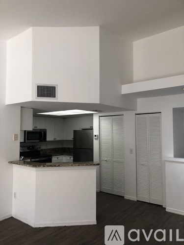 A kitchen area with a counter and cabinets.