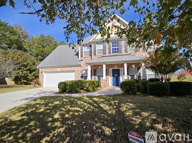 A house with a blue door and a white garage door.