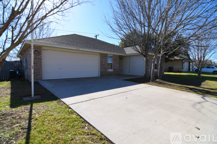 A house with a white garage door and a brown roof.
