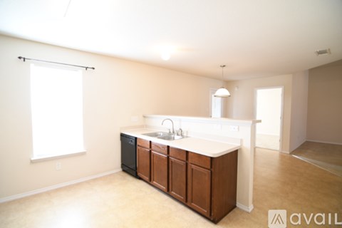 A kitchen with a sink and cabinets is available for rent.