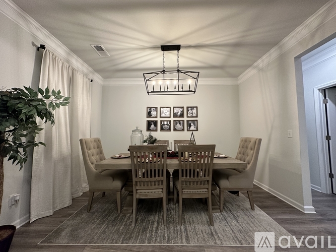 A dining room with a table set for six.