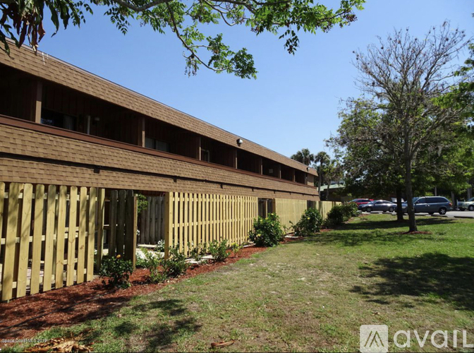 A long building with a wooden fence in front of it.