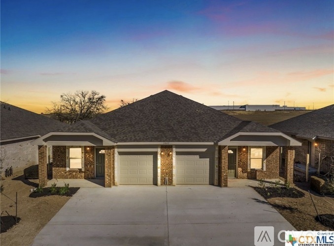 A house with a driveway in front of it.