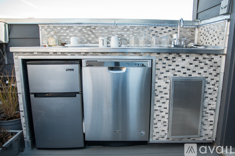 A kitchen with a stainless steel refrigerator and dishwasher.