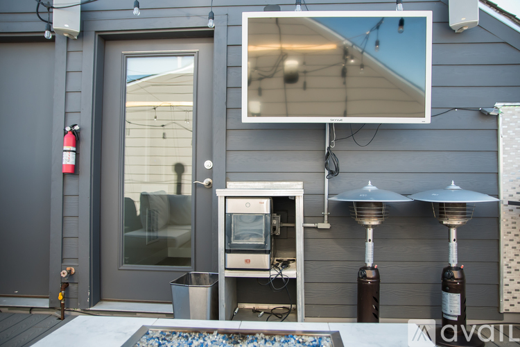 A modern house with a grey exterior and a glass door.