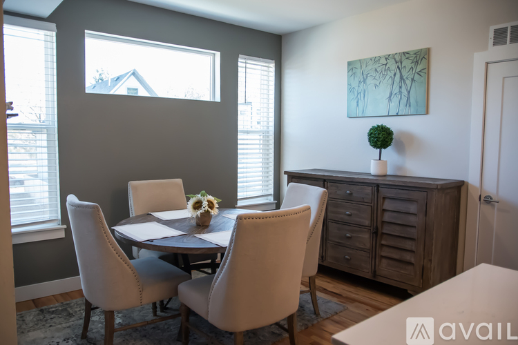 A dining room with a table and chairs.