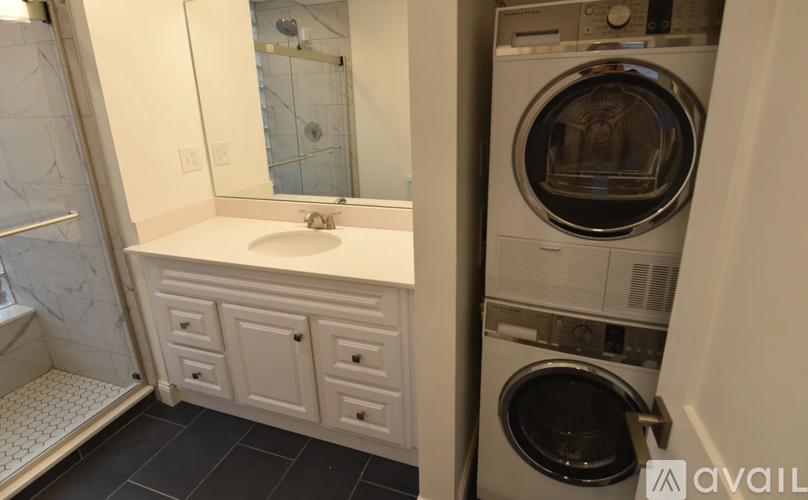 A washing machine is in a small laundry room.