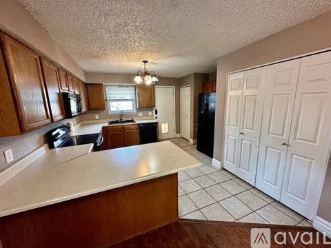 A kitchen with wooden cabinets and a white countertop.