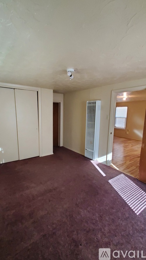 A room with a carpeted floor and a white ceiling.