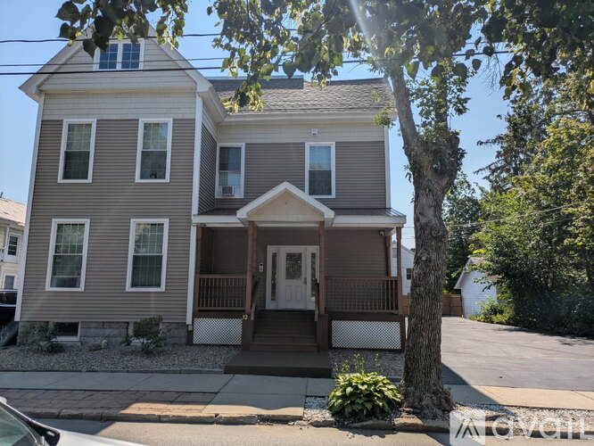 A two-story house with a brown front porch.