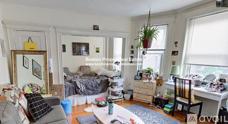 A messy room with a bed, desk, and chair.
