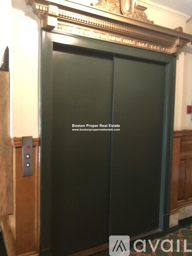 A door with a sign that says "Boston Proper Real Estate" on it.