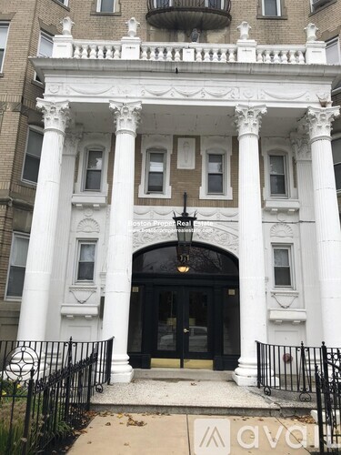 A white building with black doors and windows.