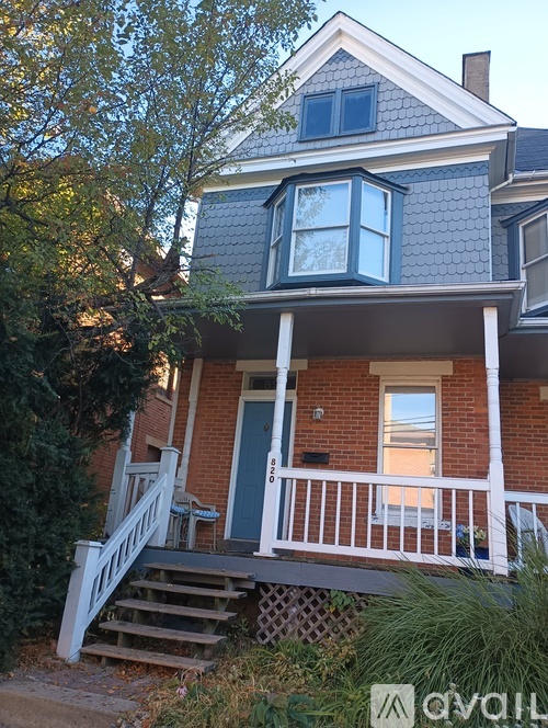A house with a blue door and a porch.
