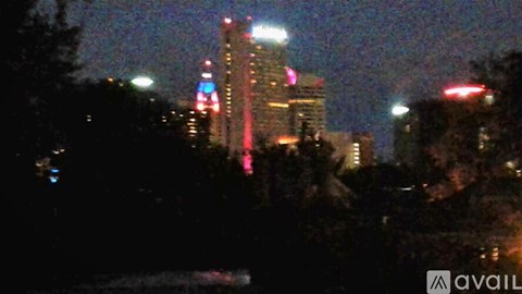 A cityscape at night with buildings lit up.
