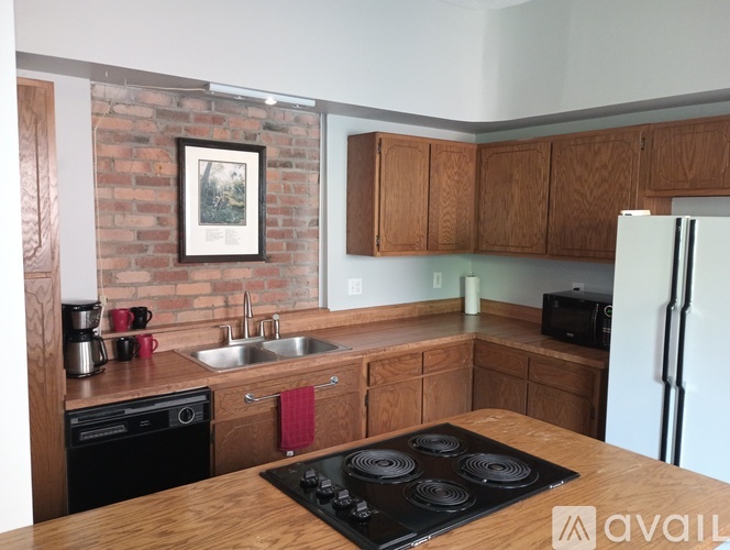 A kitchen with a stove top oven and a fridge.