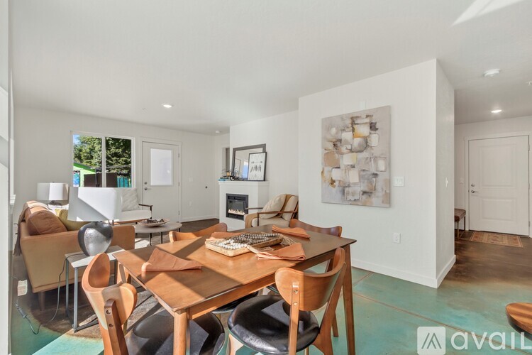 A dining room with a wooden table and chairs.