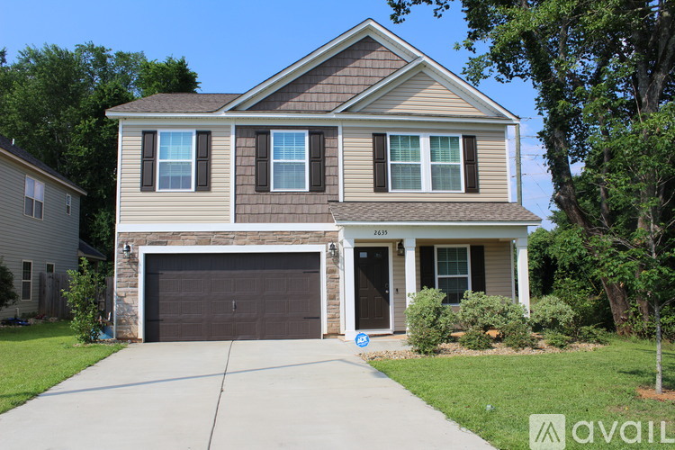 A two-story house with a garage is for sale.