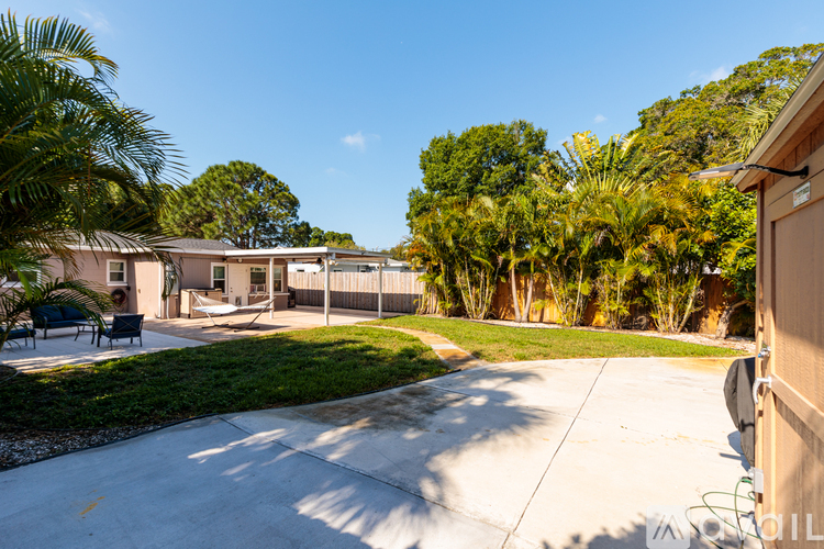 A sunny day at a residential area with houses and palm trees.