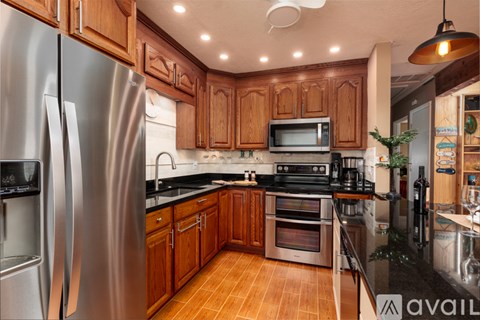 A kitchen with wooden cabinets and stainless steel appliances.