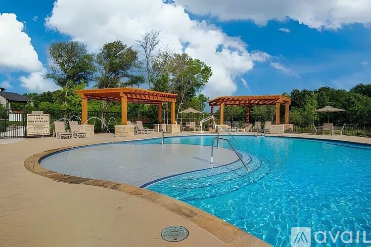 A pool with a wooden pergola over it.