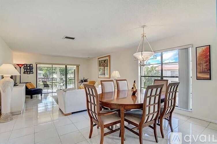 A dining room with a wooden table and chairs.