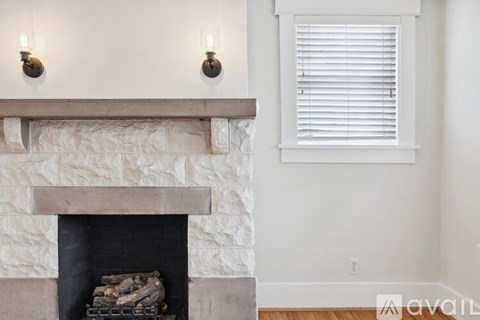 A fireplace with a stack of wood in front of it.