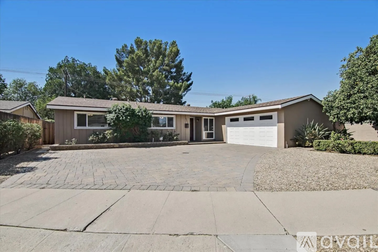 A house with a driveway in front of it is for sale.