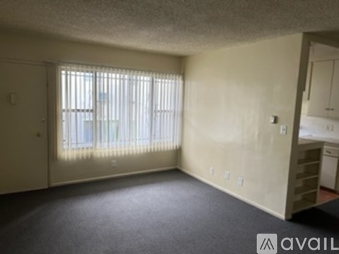 A white bathroom with a toilet, sink, and shower.