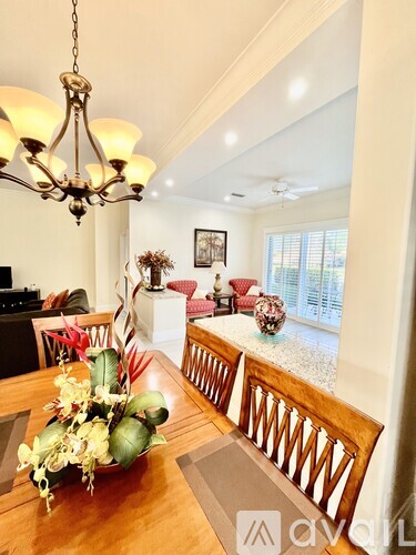 A dining room with a wooden table and chairs.