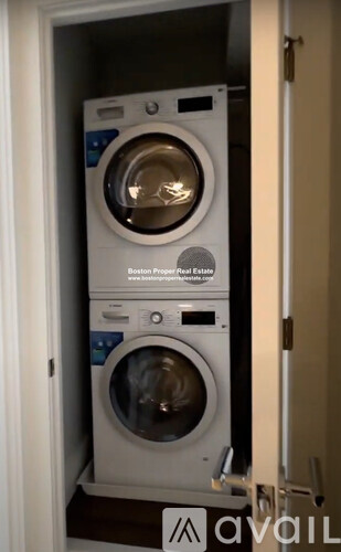 A stack of two washing machines in a small space.