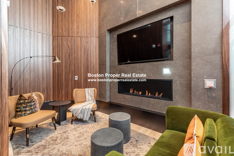 A modern living room with a fireplace and a television mounted on the wall.