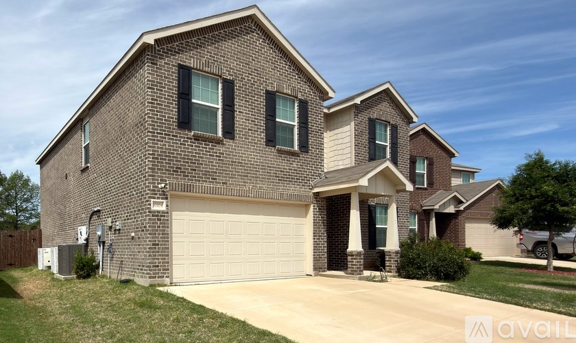 A two-story house with a garage is available for sale.