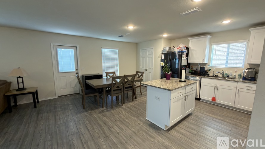 A kitchen with a table and chairs in the middle of the room.