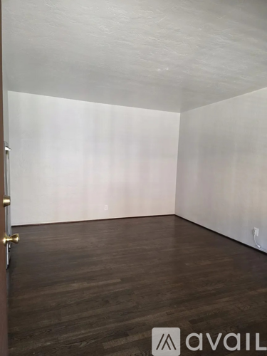 A room with wooden floors and white walls.