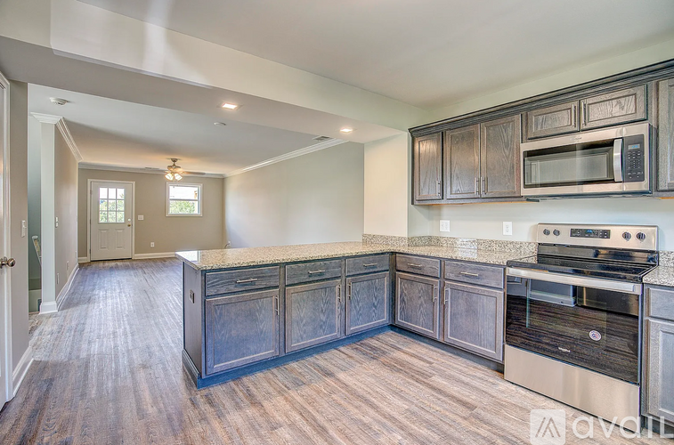 A kitchen with dark wood cabinets and stainless steel appliances.