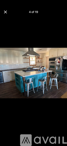 A kitchen with a table and chairs set up.