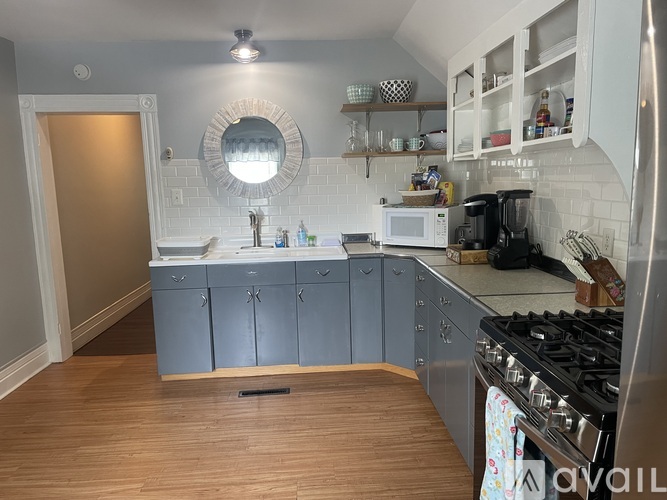 A kitchen with a stove top oven and a microwave.