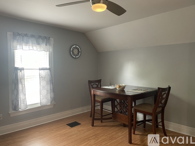 A dining room with a table set for two.