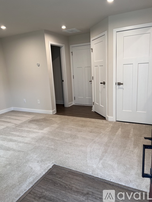 A room with a carpeted floor and white walls.