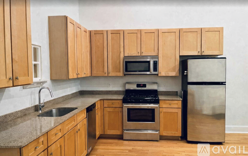 A kitchen with wooden cabinets and stainless steel appliances.