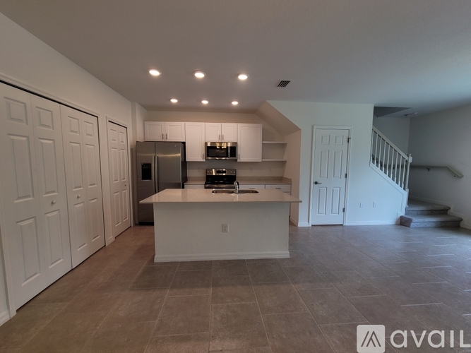 A kitchen with a refrigerator, stove, and oven is available for rent.