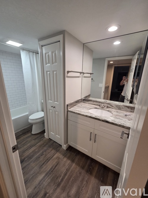 A room with wooden flooring and a ceiling fan.